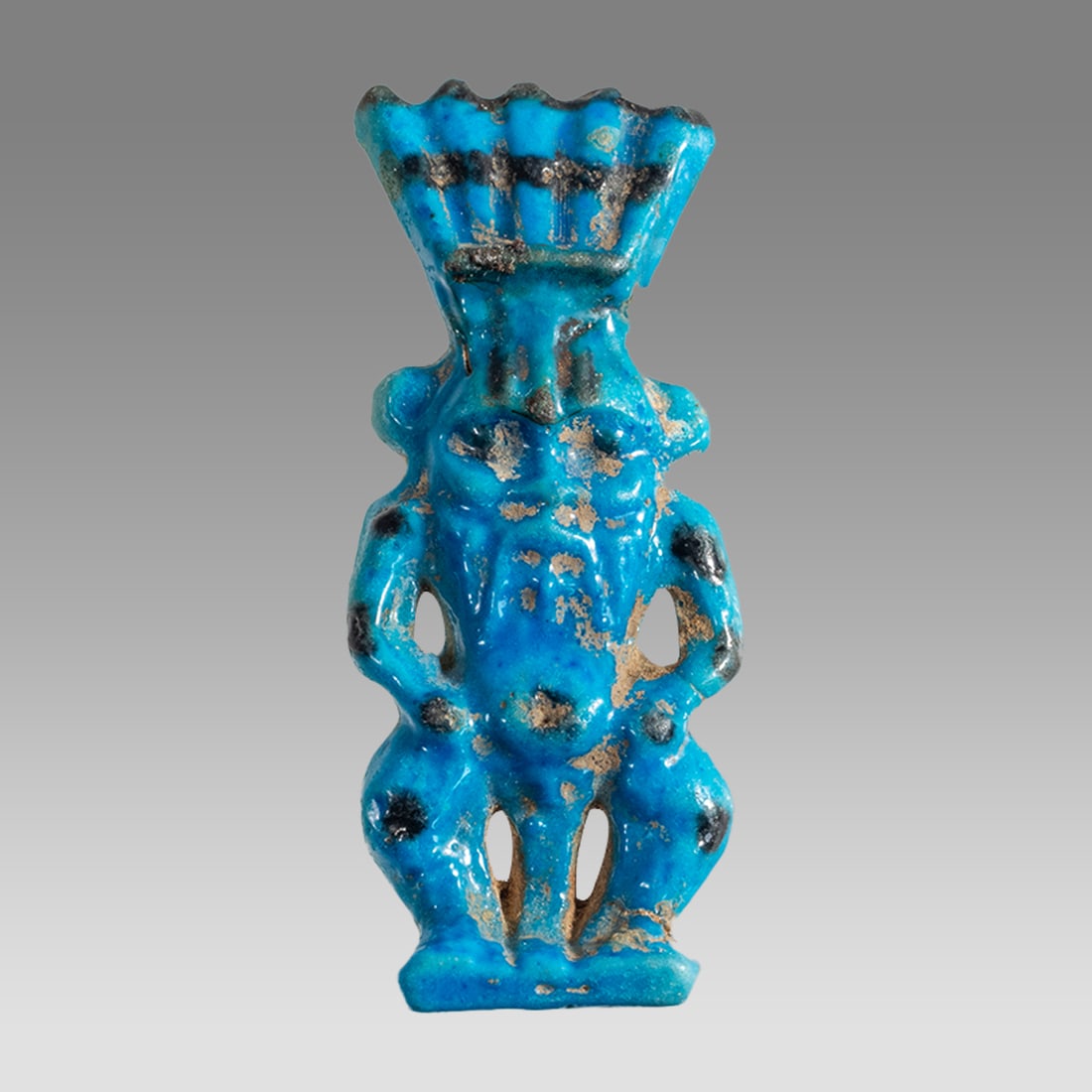 Egyptian Blue Faience Amulet Of Bes.: Egyptian Blue Faience Amulet Of Bes. Size 55 x 20 mm. Fine blue faience amulet of Bes with black details. Suspension hole through the back pillar. Age unknown? Provenance: Private collection, bought v