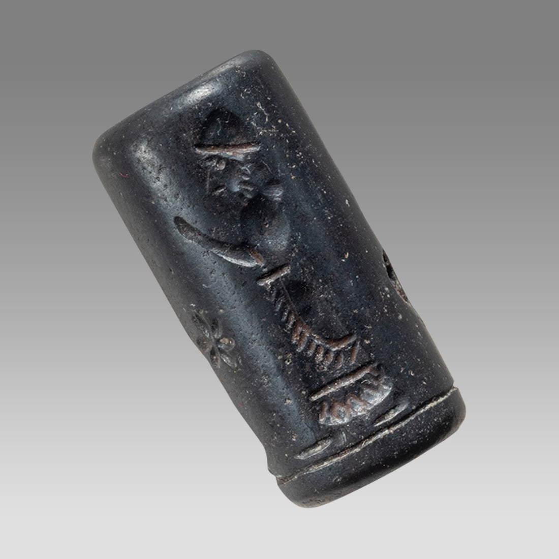 Mesopotamian Style Hematite Stone Cylinder Seal.: Mesopotamian Style Hematite Stone Cylinder Seal. Size 27 x 14 mm. Carved Hematite stone cylinder seal with presentation scene. suspension hole through. Age unknown. Provenance: Private collection, bou