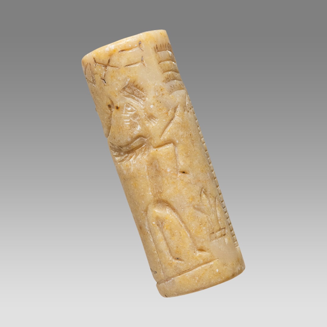 Mesopotamian Style Stone Cylinder Seal.: Mesopotamian Style Stone Cylinder Seal. Size 38 x 14 mm. Carved stone cylinder seal with presentation scene. suspension hole through. Not ancient. Provenance: Private collection, bought in Grays Marke