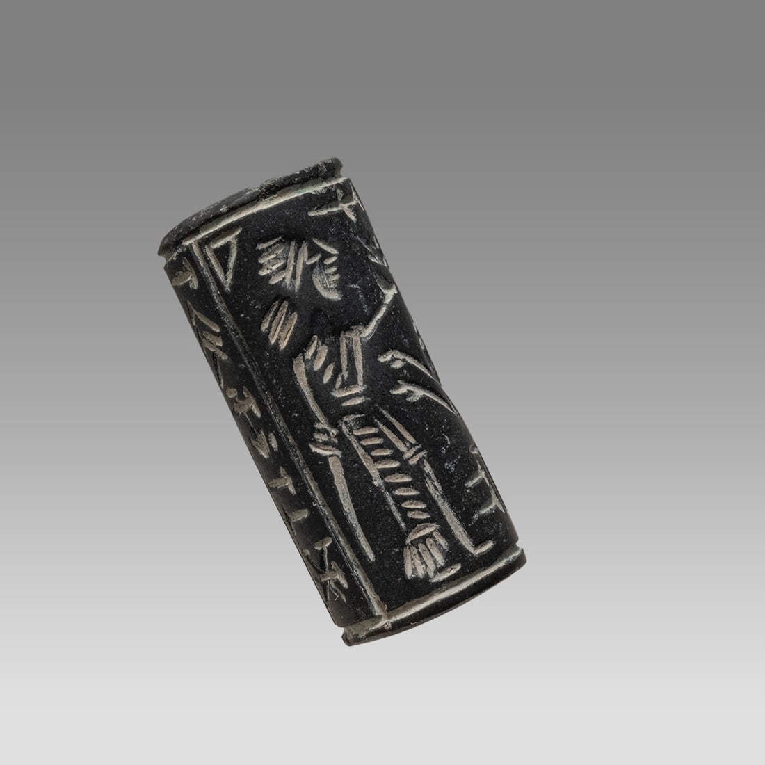Mesopotamian Style Stone Cylinder Seal.: Mesopotamian Style Stone Cylinder Seal. Size 40 x 18 mm. Carved stone cylinder seal with presentation scene and Sumerian inscription. suspension hole through. Not ancient. Provenance: Private collecti