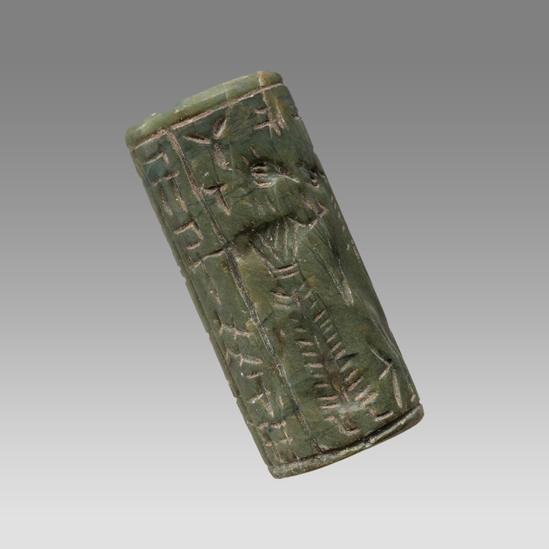 Mesopotamian Style Stone Cylinder Seal.: Mesopotamian Style Stone Cylinder Seal. Size 42 x 18 mm. Carved stone cylinder seal with presentation scene and Sumerian inscription. suspension hole through. Not ancient. Provenance: Private collecti
