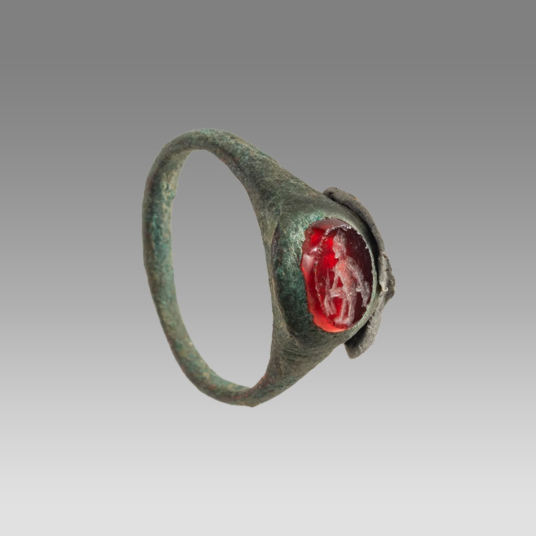 Ancient Roman Bronze Ring With Intaglio c.2nd century AD.: Ancient Roman Bronze Ring With Intaglio c.2nd century AD. Ring Size 5.8, band size 20 mm. Ancient Roman bronze finger ring, with carnelian small intaglio depicting standing nude youth. Wearable. Prove
