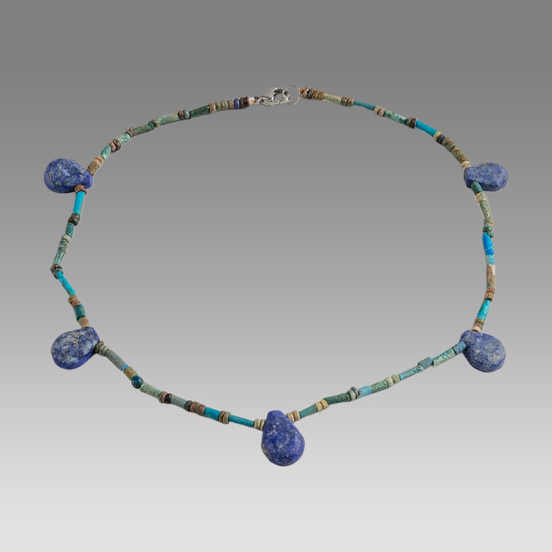 Ancient Egyptian Faience Bead Necklace c.300-50 BC.: Ancient Egyptian Faience Bead Necklace c.300-50 BC. Size 16 1/4 inches length. Great Looking single strand Faience Bead necklace with modern lapis beads. wearable. Provenance: Ex Secret Eyes Gallery N