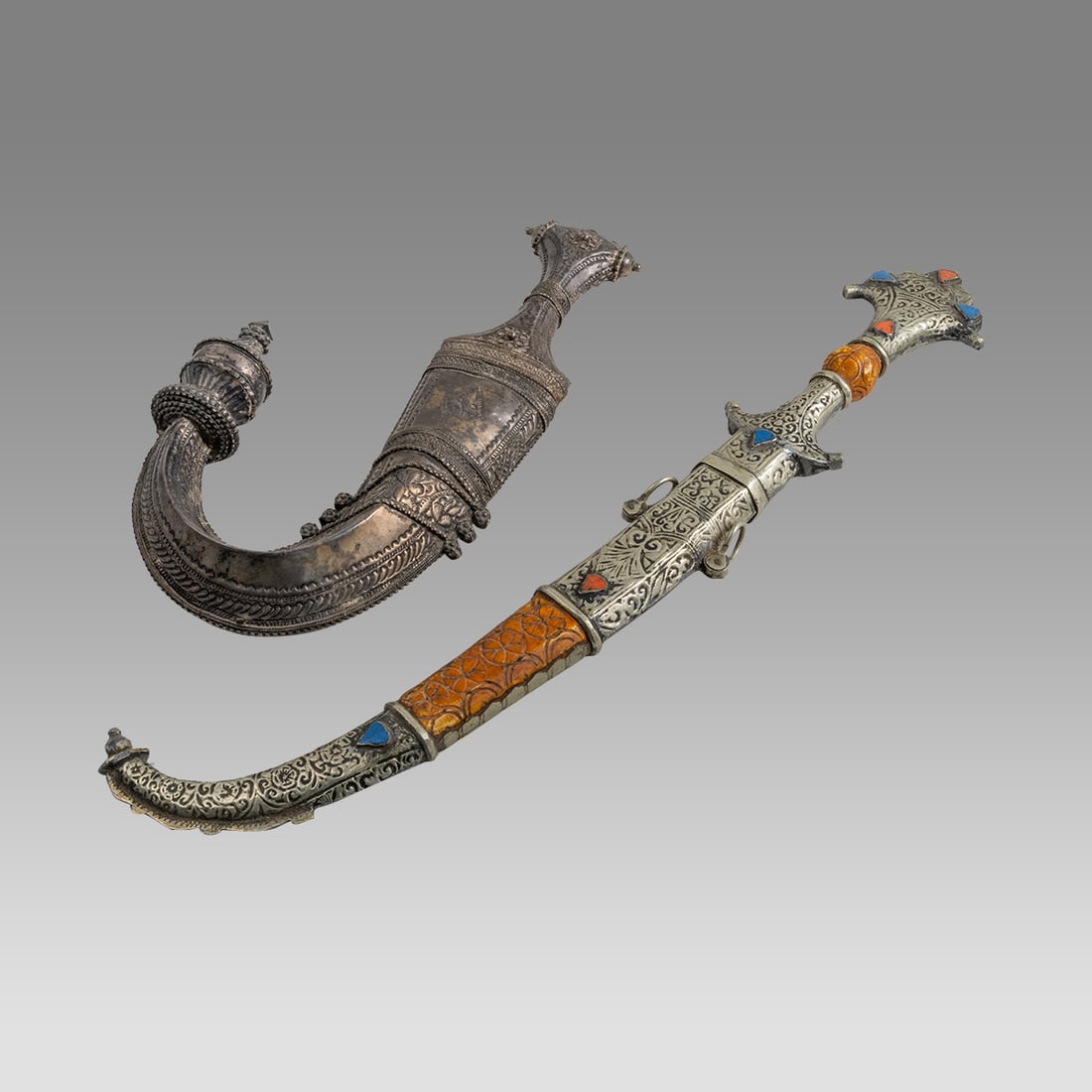 Lot of 2 Antique Middle Eastern, Yemen Daggers.: Lot of 2 Antique Middle Eastern, Yemen Daggers. Size 17 1/2 - 11 inches length. A silver Jambiya Traditional curved dagger, together with Syrian dagger with jewels. From The Estate of Farnces Denier A