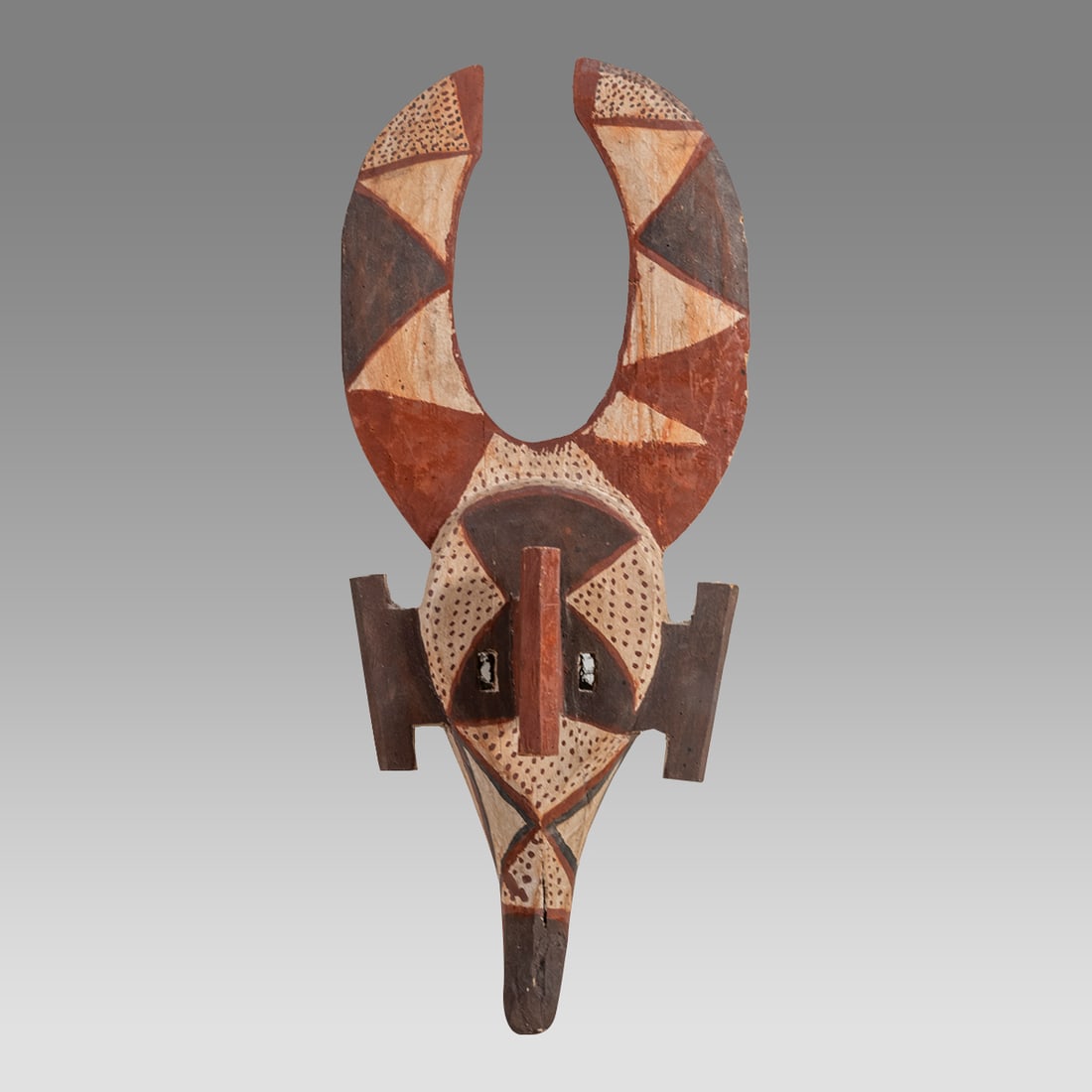 African Ceremonial Wood Mask.: African Ceremonial Wood Mask. Size 24 inches high, 10 inches width. The mask features a long protruding snut and abstract facial features, decorated with white, brown and reddish paint. Ex New York Ci