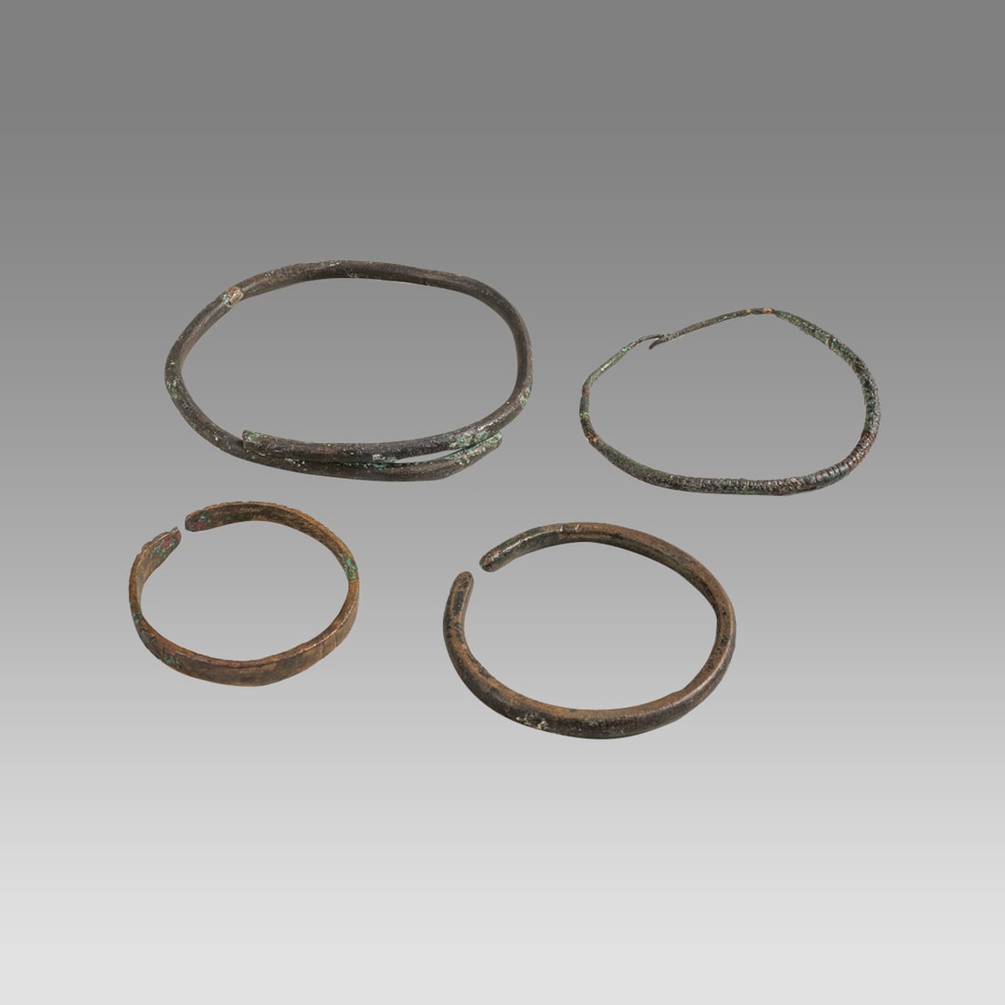 Lot of 4 Ancient Roman, Bronze Bracelets c.1st-3rd century AD.: Lot of 4 Ancient Roman, Bronze Bracelets c.1st-3rd century AD. Size 1 5/8 - 3 inches diameter. Fine collection of 4 cast bronze snake form bracelets. Ex Florida collection.
