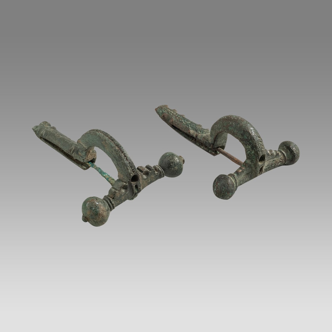 Lot of 2 Ancient Roman, Bronze Fibulas c.1st-3rd century AD.: Lot of 2 Ancient Roman, Bronze Fibulas c.1st-3rd century AD. Size 2 1/4 inches length. Fine collection of 2 cast bronze cross-bow type fibulas with original pins. Ex Florida collection.