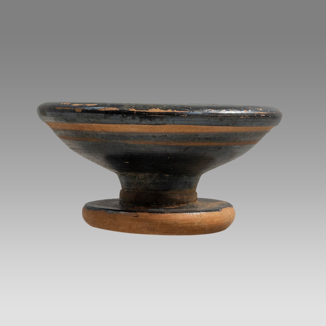 Ancient Greek Blackware Pottery Bowl c.350 BC.: Ancient Greek Blackware Pottery Bowl c.350 BC. Size 2 inches high. 4 inches diameter. Fine small blackware footed bowl. Ex NJ collection.
