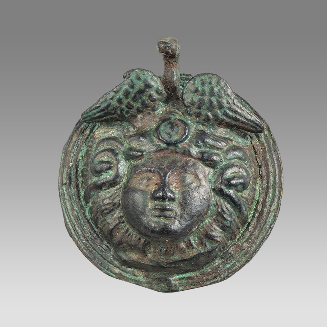 Ancient Roman Bronze Medusa Applique c.1st-2nd century AD.: Ancient Roman Bronze Medusa Applique c.1st-2nd century AD. Size 2 3/8 inches length. Fine cast bronze Medusa head Applique in high relief with choice patina. Fine quality and details. Provenance: From
