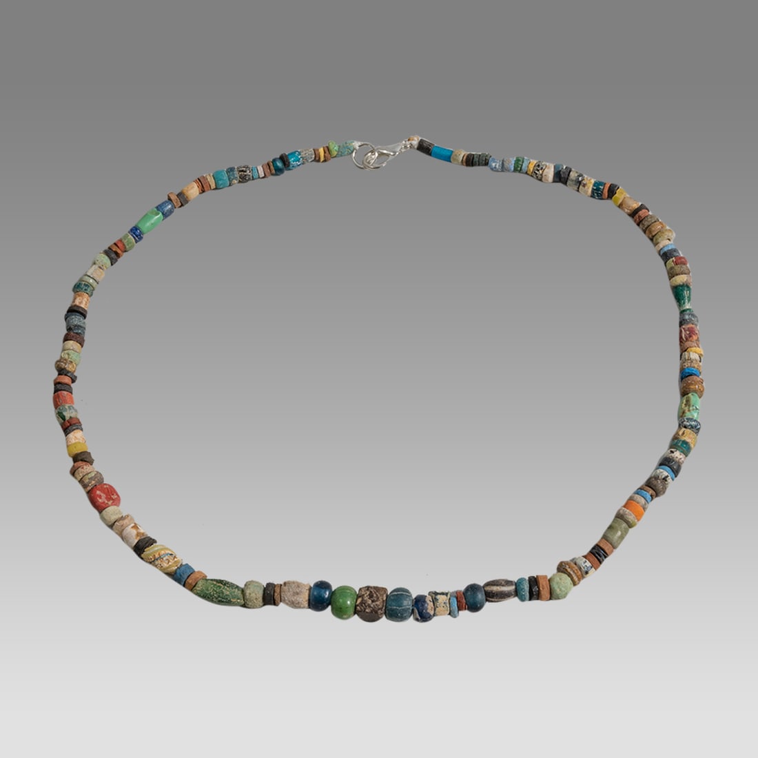 Ancient Roman Glass Bead Necklace c.200 AD.: Ancient Roman Glass Bead Necklace c.200 AD. Size 16 1/2 inches length. Great Looking single strand glass bead necklace. wearable. Provenance: Ex Secret Eyes Gallery New York 1970's-1980's