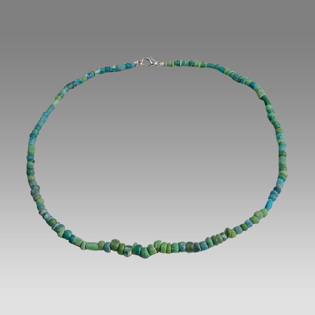 Ancient Roman Glass Bead Necklace c.200 AD.: Ancient Roman Glass Bead Necklace c.200 AD. Size 16 3/4 inches length. Great Looking single strand glass bead necklace. wearable. Provenance: Ex Secret Eyes Gallery New York 1970's-1980's