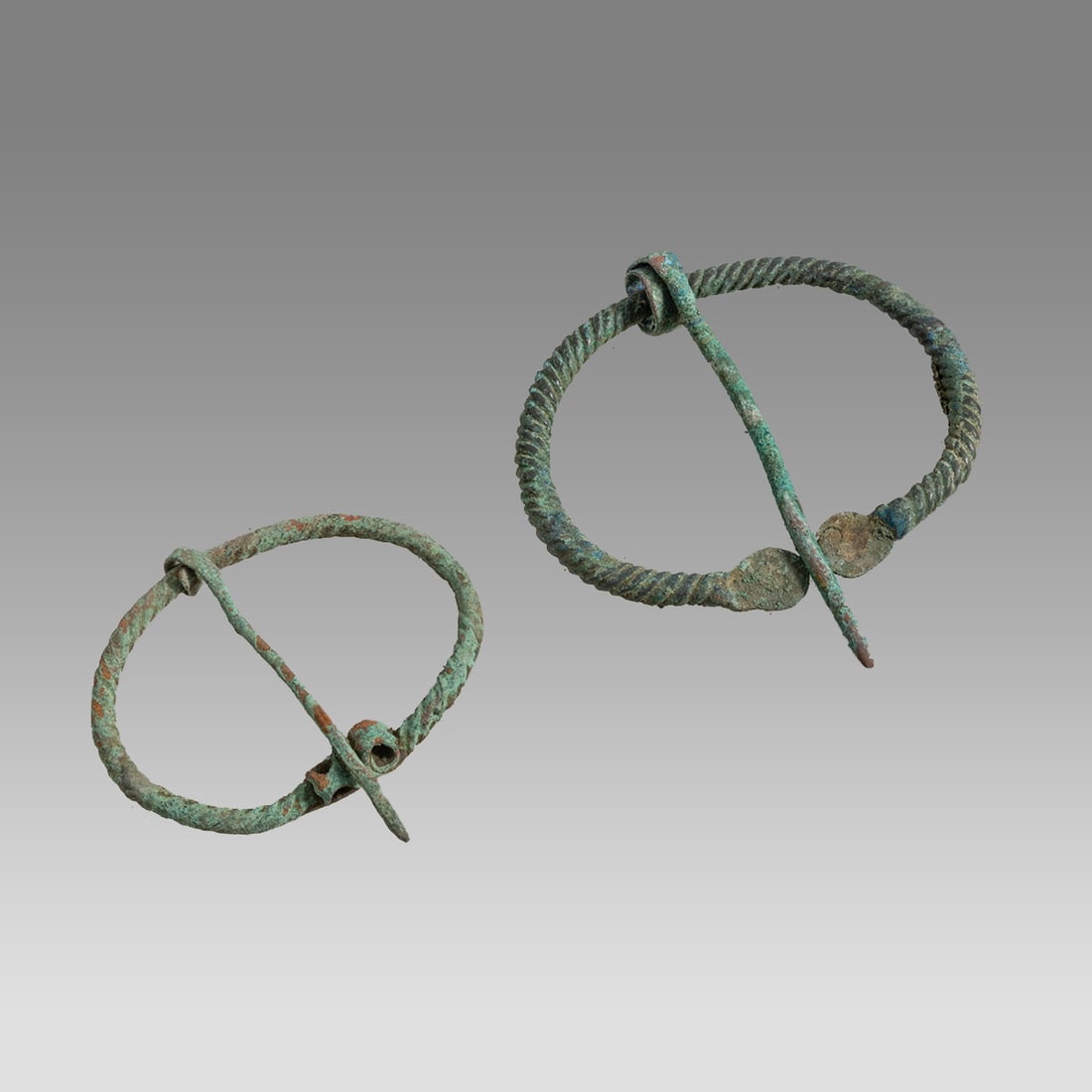 Ancient Kievan, Viking Penannular Bronze Fibulas c.800-1100 AD.: Ancient Kievan, Viking Penannular Bronze Fibulas c.800-1100 AD. Size 2 1/4- 2 1/2 inches length. A collection of 2 bronze fibulas. Provenance: From a private Altmar, New York Collection.