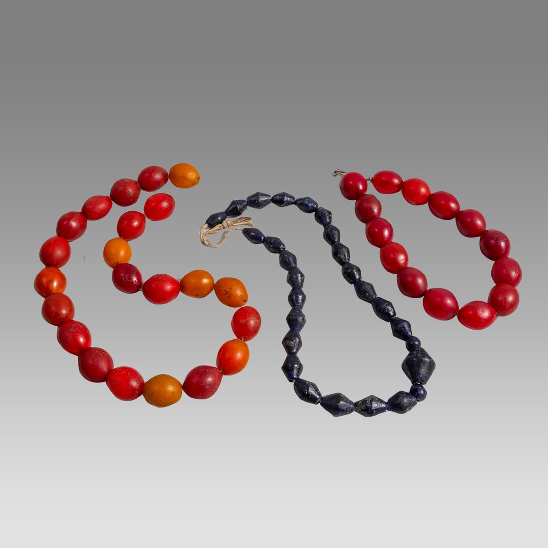 Mauritania, Phenolic Amber Trade Beads, blue glass bead Necklaces. (3): Mauritania, Phenolic Amber Trade Beads, blue glass bead Necklaces. (3) Size 21-24 inches length. Bead size 12 - 28 mm. Lot of 2 Large Phenolic Red Amber beads necklaces. Together with blue glass bead