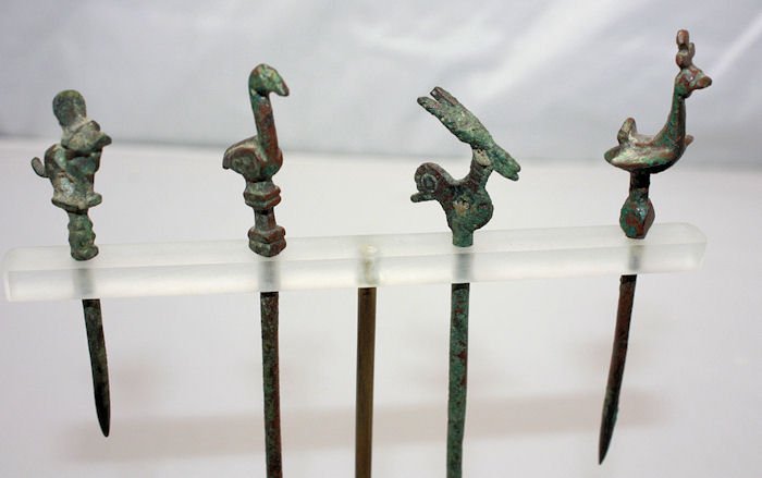 A Lot Four Ancient Bronze Pins w/ Animal Heads: A Lot Four Ancient Bronze Pins w/ Animal Heads, Comprised of a Luristan Ibex pin with stylized bird on its back. A Roman bird/goose pin, a Byzantine bird pin and a pin in the form of a bull (possibly 