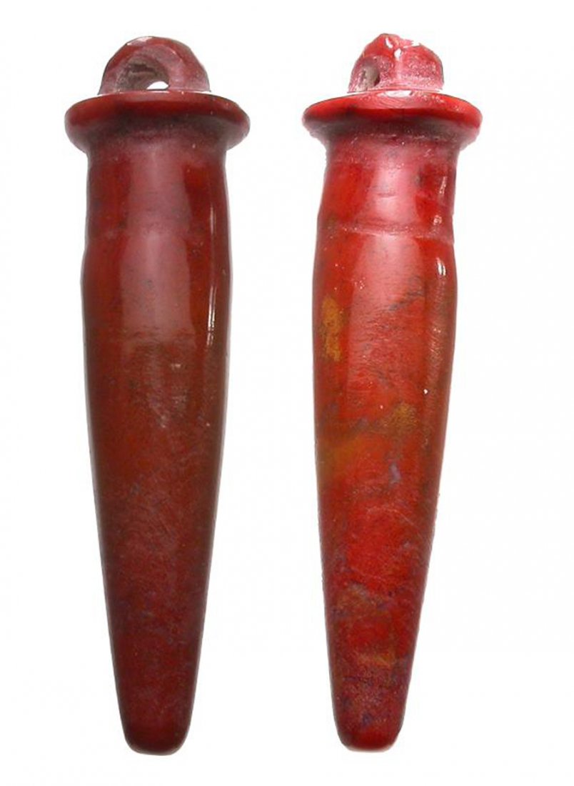 Egyptian Carnelian Papyrus Column Amulet, Western: An orange example of an amulet with loop. The piece measures 30 mm; is intact; and has nice color. (Id: L0613), Est. 125