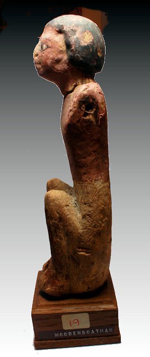 Ancient Egyptian gesso-painted and carved wood boatman: Ancient Egyptian gesso-painted and carved wood boatman Late Period, 26th-30th Dynasties. seated with knees close to body, hair and facial features in black with white highlights, his skin painted red 