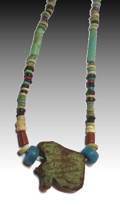 Ancient Egyptian Faience beads Necklace c.700 BC: Ancient Egyptian Faience beads Necklace Late Period c.700 B.C. - 100 A.D.A necklace strung with mostly multicolor disc beads and has an Uzat eye of horus center pendant. (Eye of horus size 1 inch.)App