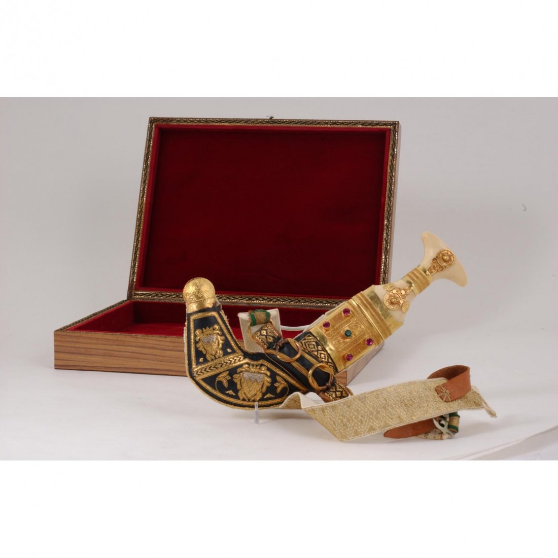 Middle Eastern, gilded Presentation Dagger with Case: Middle Eastern, gilded Presentation Dagger with Case late 20th century, carved bone handle, case with embellished glass jewels, velvet lined case.Knife 13 in.Good estate condition.