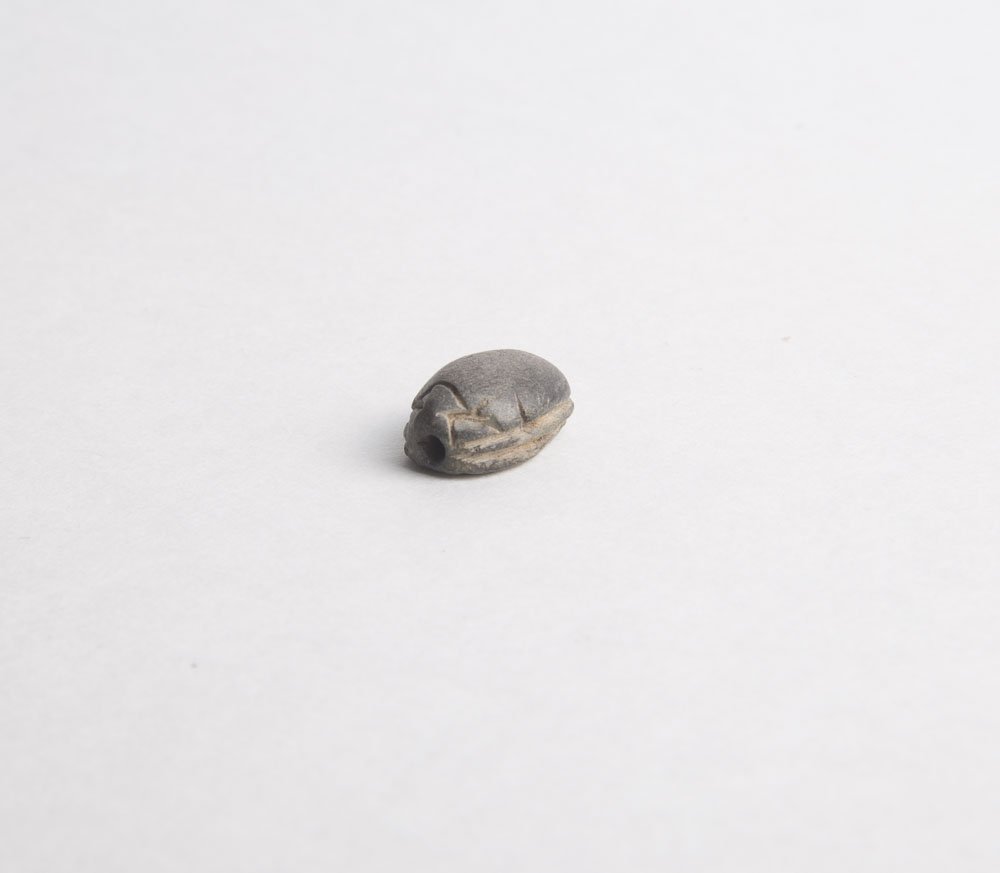 Ancient Egyptian Steatite Stone Scarab Ca. 1500-30 B.C.: Ancient Egyptian Steatite Stone Scarab Ca. 1500-30 B.C. Size 16 x 11 mm. Beautiful Steatite Stone scarab carved with a Goat seated, surface weathering and losses. Provenance:NYC collection, ex. Tarshi