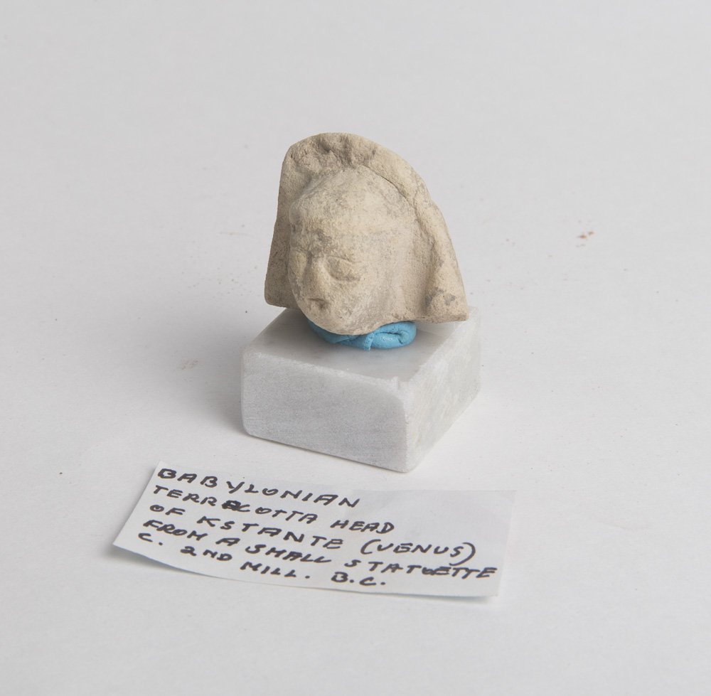 Ancient Babylonian Terracotta Head of Kstante Venus c.2: Ancient Babylonian Terracotta Head of Kstante Venus c.2nd millennium BC. Size of the head : 1 1/4 inches high. a Nice fragment from a statue, custom mounted on marble stand.Provenance: Ex Lester Gross