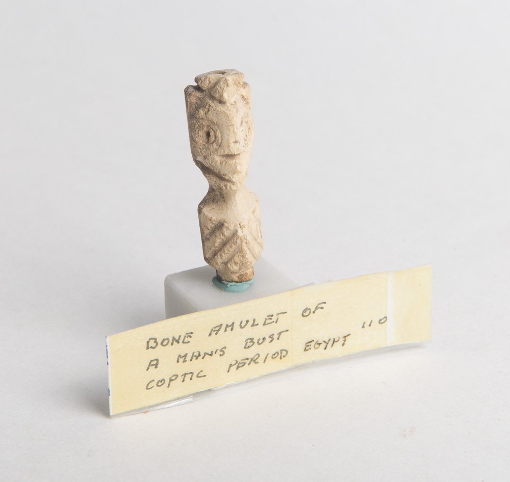 Ancient Coptic carved bone amulet of a Man c.5th cen AD: Ancient Coptic carved bone amulet of a Man c.5th century AD. Size 1 1/2 inches high (38 mm) Ancient Egypt carved bone amulet of a Man. mounted on marble block. Perfect condition. Provenance: Ex Lester