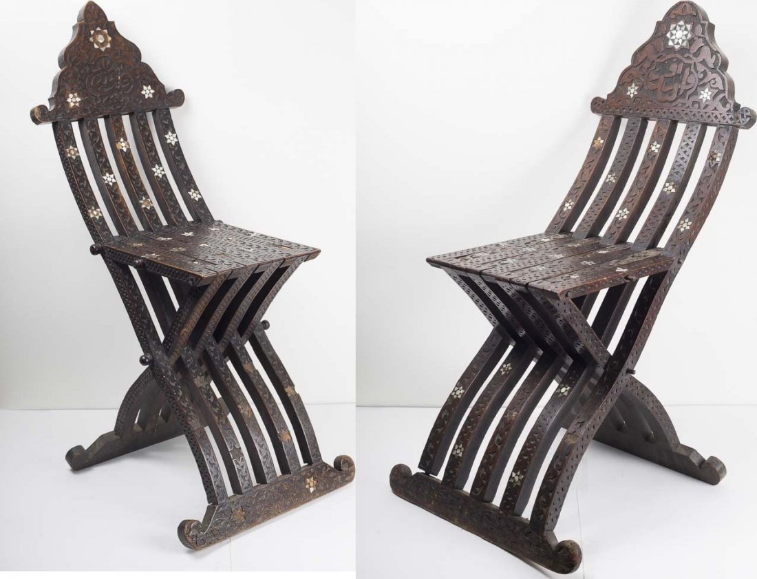 A Pair of 19th century Syrian Moorish Wood chairs: A Pair of 19th century Syrian Moorish Wood chairs. Size 37 1/2 inches high x 13 3/4 inches deep x 11 inches wide.Fine carved wood folding chairs decorated with floral design with Arabic Calligraphy. C