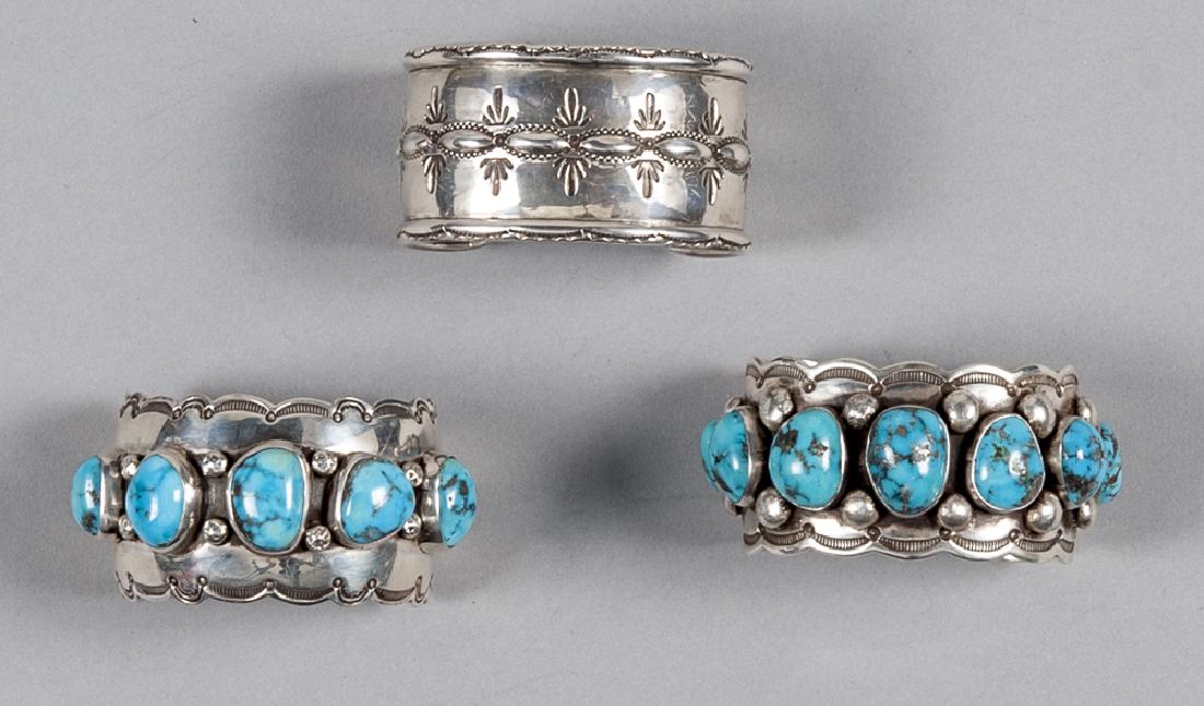 Two Greg Lewis, Laguna Pueblo, New Mexico handmad: Two Greg Lewis, Laguna Pueblo, New Mexico handmade silver cuff bracelets, inset with five and seven turquoise cabochons, together with another Lewis cuff bracelet.