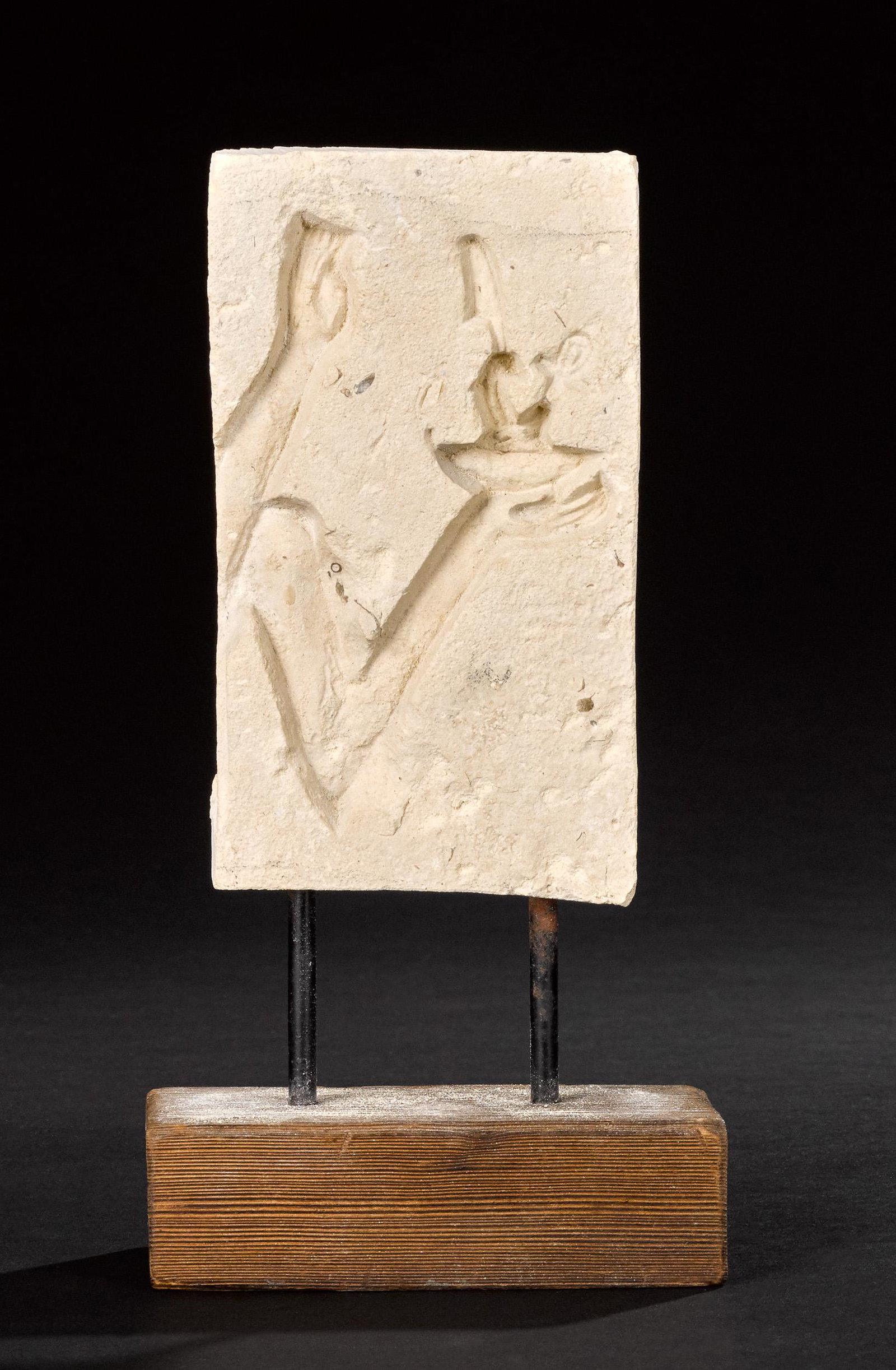 Egyptian limestone sunk relief fragment: Egyptian limestone sunk relief fragment, Late Period 700-30 B.C., with hands holding a statue of Maat, the goddess of truth, 6 3/4'' h. (excluding base) Provenance: A New York City collection, acquire