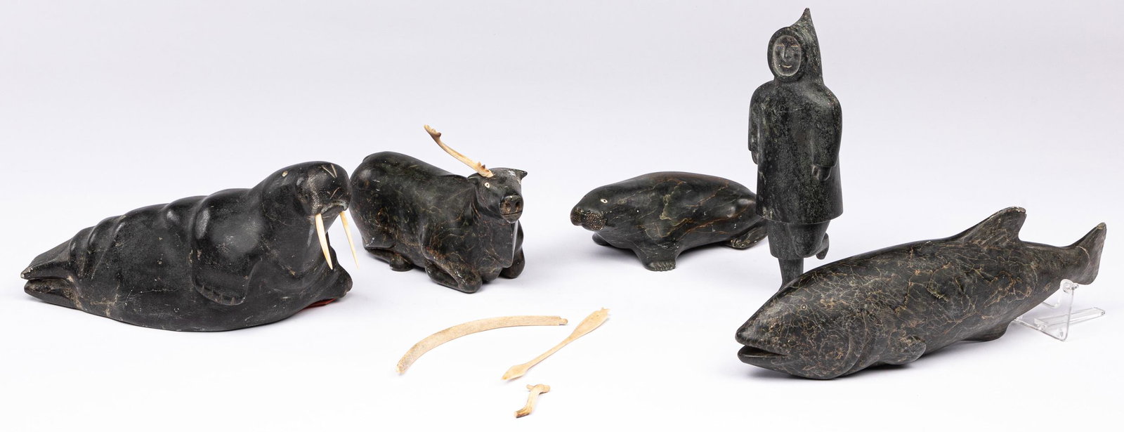 Five Inuit stone carvings: Five Inuit stone carvings, largest - 16'' l.