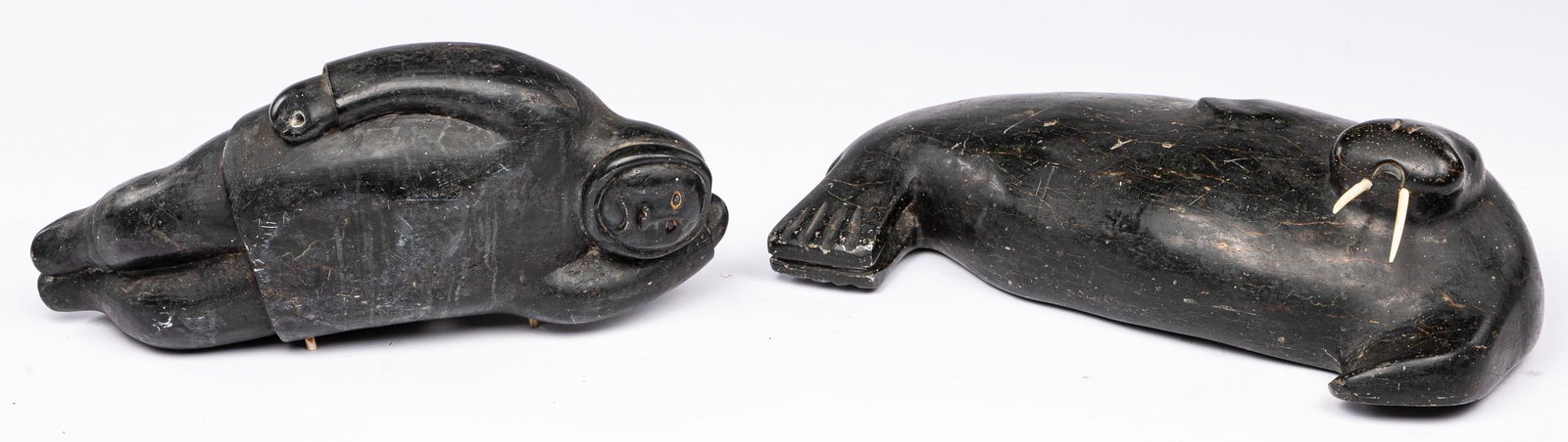 Large Inuit carved stone figures: Large Inuit carved stone walrus and reclining figure 20 1/2'' l, 19'' l.