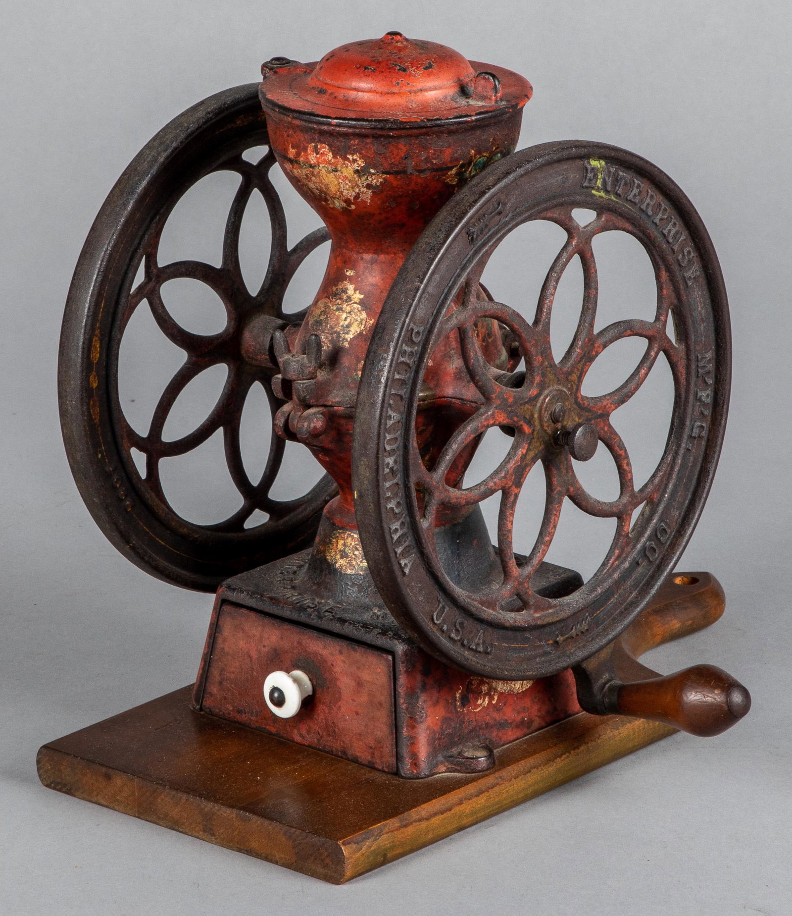 Enterprise Mfg. Co. cast iron coffee grinder: Enterprise Mfg. Co. Philadelphia cast iron coffee grinder, 19th c., mounted to a later pine board, 12 1/2'' h.