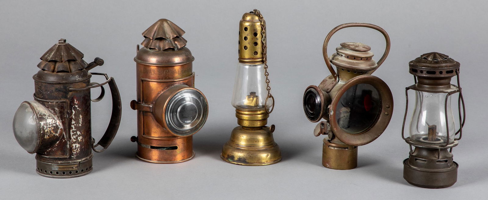 Five lanterns: Five lanterns, 19th c., to include Boat Signal Lantern, Rose Mfg. Co. Neverout brass carriage lantern, Dietz Sport, Dietz Police Flashlight, and a brass skaters lamp, tallest - 9 1/4''.
