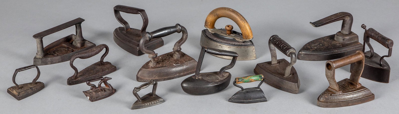 Collection of fourteen cast iron sad irons: Collection of fourteen cast iron sad irons, 19th c.