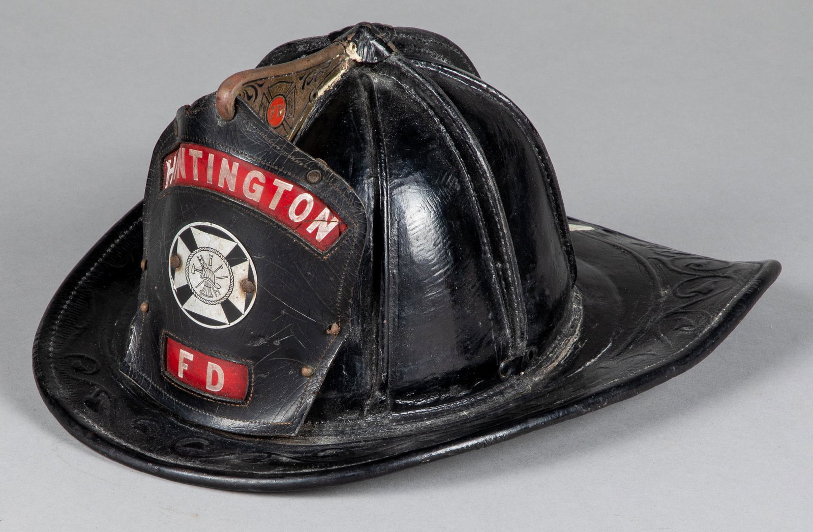Cairns leather fire helmet, early 20th c.: Cairns leather fire helmet, early 20th c., with Huntington FD front badge.