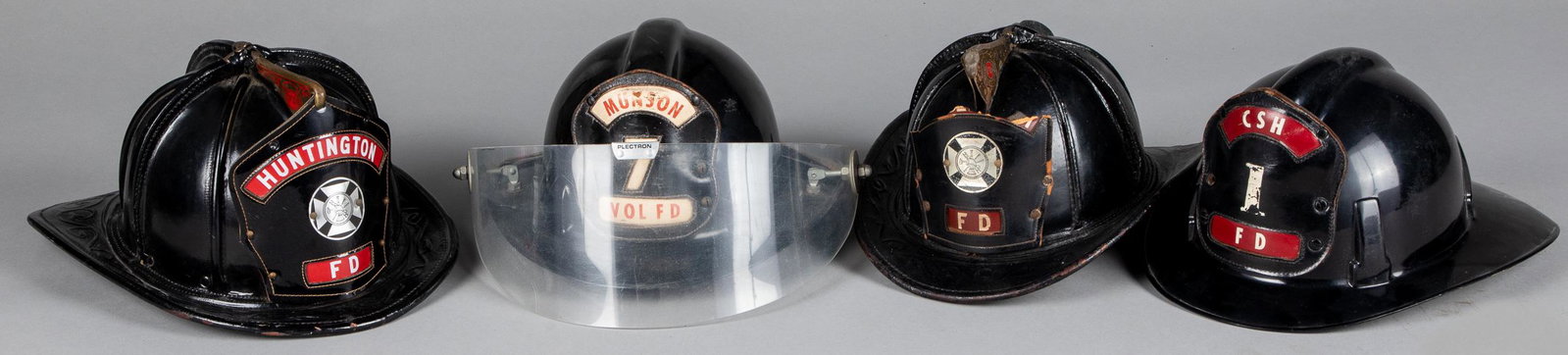 Two Cairns leather fire helmets, etc.: Two Cairns leather fire helmets, 20th c., with Huntington FD front badge, together with two contemporary plastic helmets.