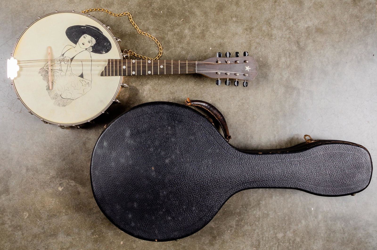 Banjo mandolin, 20th c., 10 1/2'' dia.: Banjo mandolin, 20th c., 10 1/2'' dia., with Spanish Maja on head, together with a case.