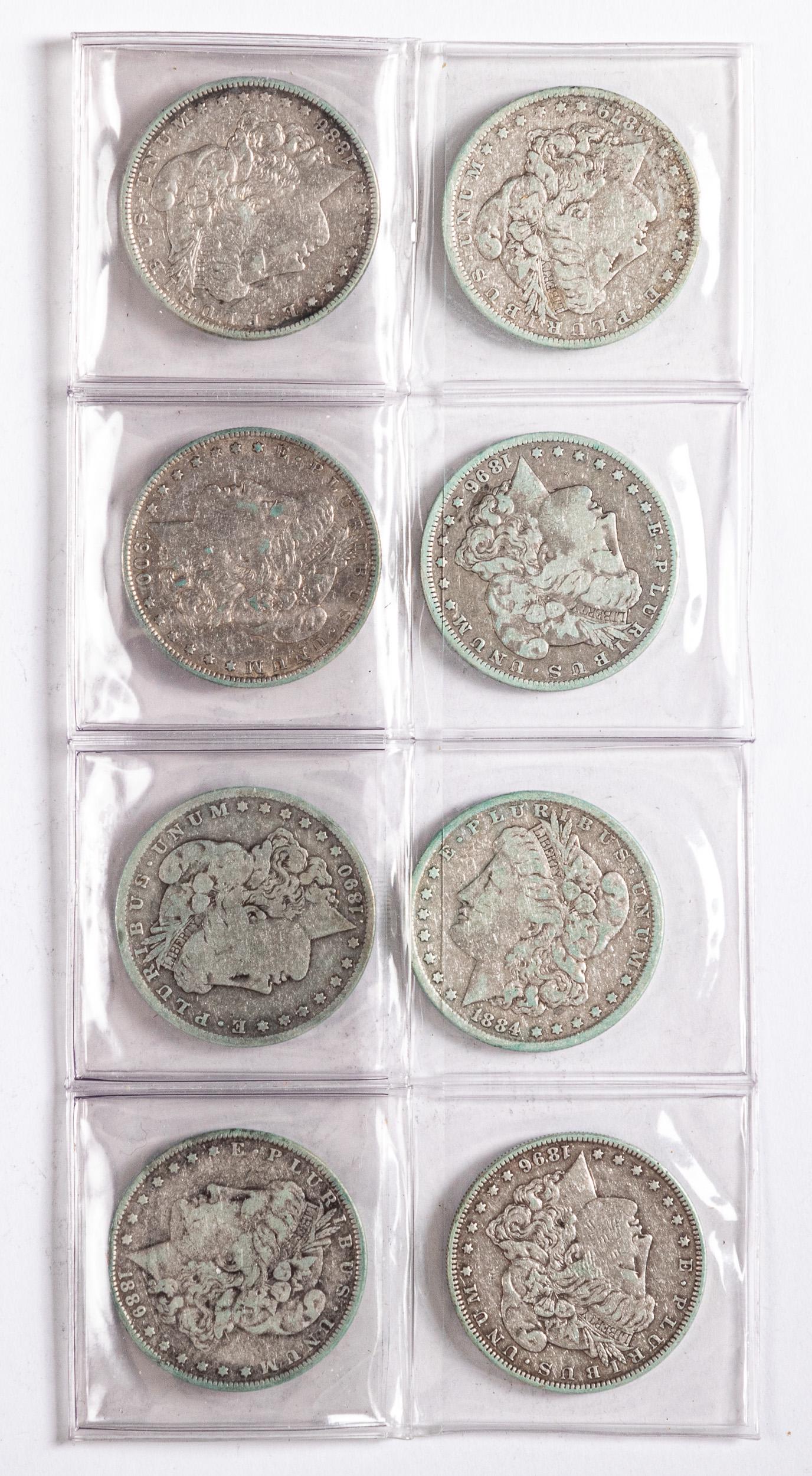 Eight Morgan silver dollars: Eight Morgan silver dollars.
