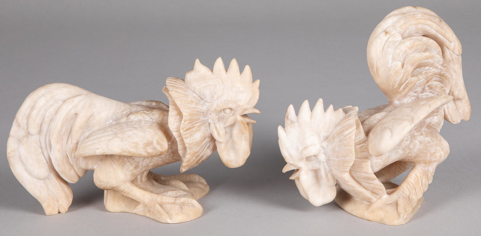 Pair of carved alabaster roosters: Pair of carved alabaster roosters, 6 1/2'' h. and 8 1/4'' h.