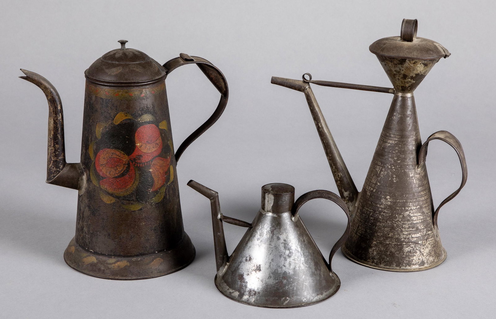 Pennsylvania toleware coffee pot, etc.: Pennsylvania toleware coffee pot, 19th c., together with two other tin pots.