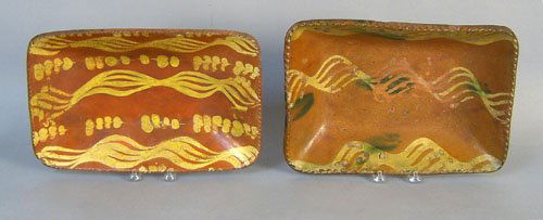 Two redware loaf dishes, 19th c., 9 1/2'' h., 14 3: Two redware loaf dishes, 19th c., 9 1/2'' h., 14 3/4'' w. and 10 1/2'' h., 14'' w.