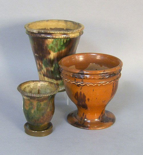 Three redware flower pots, 19th c., 5 1/4'' h., 7: Three redware flower pots, 19th c., 5 1/4'' h., 7 1/4'' h., and 8'' h.