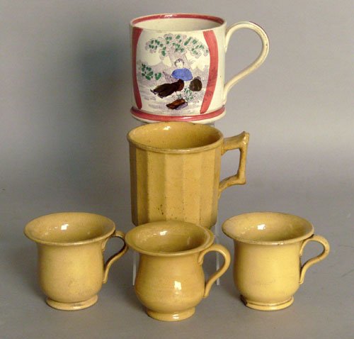 Four yelloware mugs, together with a pearlware mu: Four yelloware mugs, together with a pearlware mug, tallest - 4'' h.