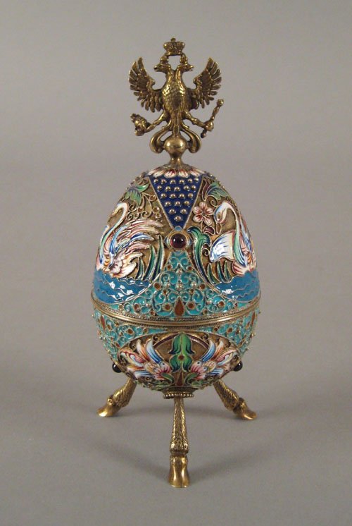Russian silver gilt and enamel egg, ca. 1900, w: Russian silver gilt and enamel egg, ca. 1900, with swan decoration and splayed hoof feet with double headed eagle finial, 5'' h., approx. 4.30 ozt.