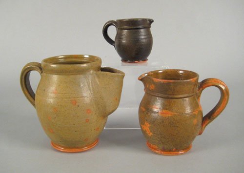 Three redware pitchers, inscribed Thomas Stahl: Three redware pitchers, inscribed Thomas Stahl 1937, all with mottled green glazing.