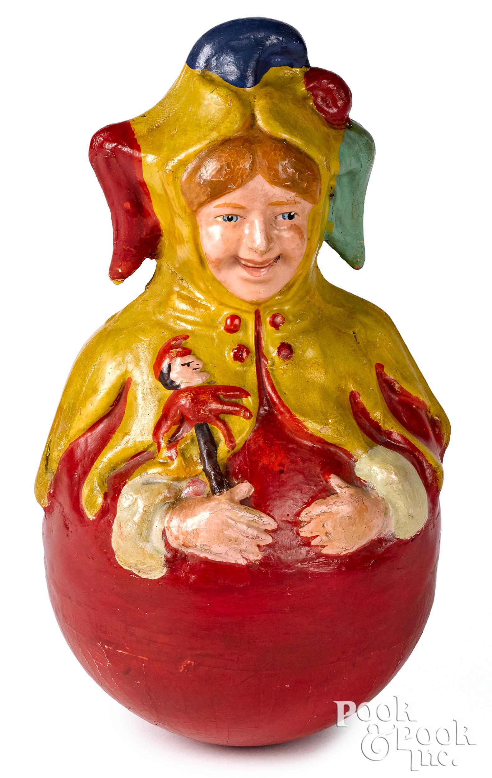 Schoenhut composition jester rolly dolly: Schoenhut composition jester rolly dolly, holding a punch figure, in a vibrant outfit, 9 1/2'' h. Provenance: Noel Barrett Auctions. Competitive In-House shipping is available for this lot.
