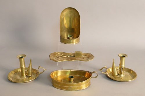 George III brass chambersticks, a snuffer and tra: George III brass chambersticks, a snuffer and tray, and another brass lighting device.