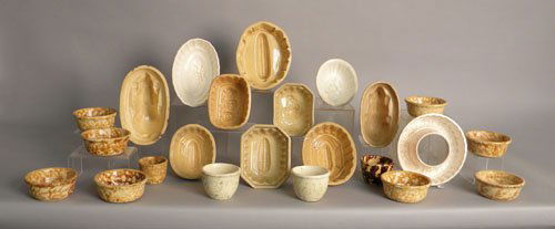 Eleven yellowware pudding molds, together with tw: Eleven yellowware pudding molds, together with twelve Spode custard dishes.