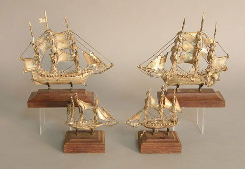 Four miniature silver ship models on stands.: Four miniature silver ship models on stands.