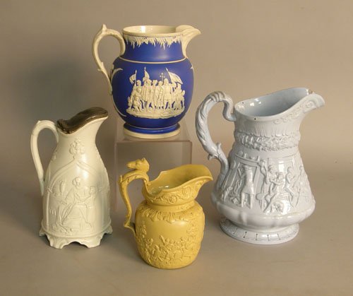 Two salt glaze pitchers together with a tavern sc: Two salt glaze pitchers together with a tavern scene pitcher and a jasperware pitcher.