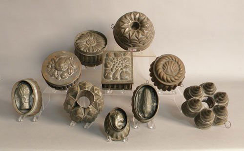Group of ten tin food molds, 19th c., including s: Group of ten tin food molds, 19th c., including sheaf of wheat, corn, fruit, etc.